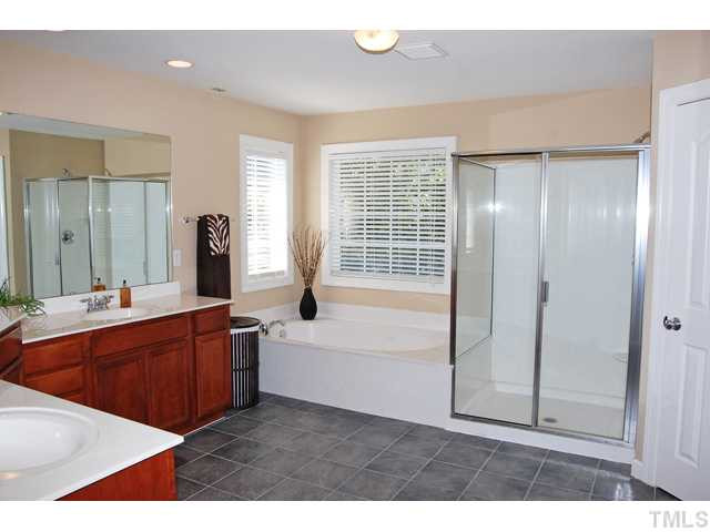 9219 Stone Mountain Road Raleigh, NC 27613 - Photo 15 of 25 The master bath has His & Her vanities, a jetted garden tub, walk-in shower, separate water closet, and tile floors. Master Bath/Spa