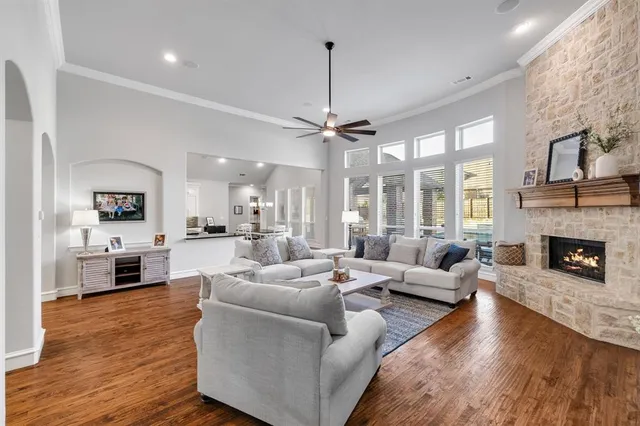 a living room with furniture fireplace and a large window