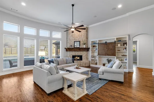 a living room with furniture fireplace and a large window