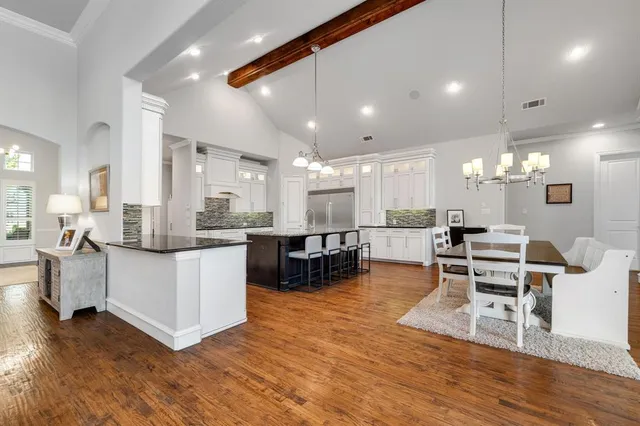 a large kitchen with a table and chairs
