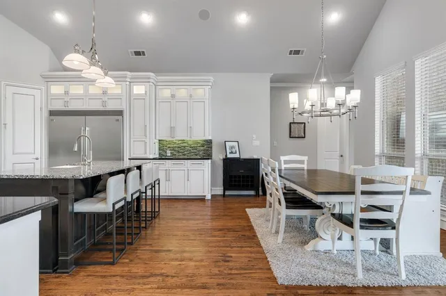 a dining room filled with furniture and wooden floor