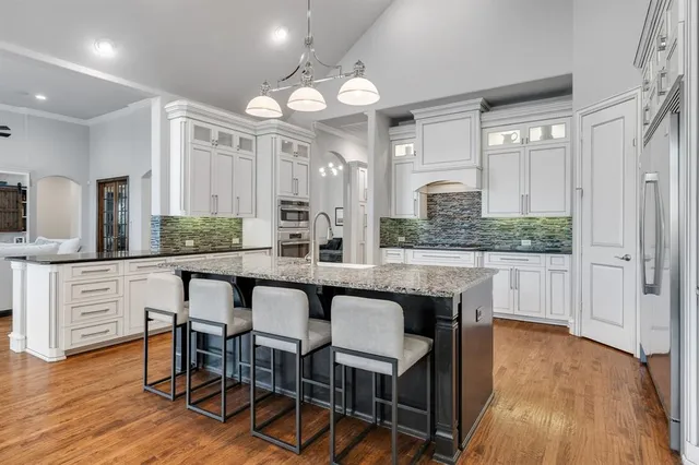 a large kitchen with a table and chairs