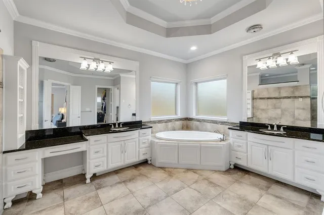 a bathroom with a granite countertop shower mirror and a sink