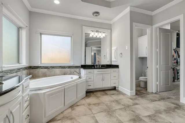 a living room with furniture a flat screen tv and a window