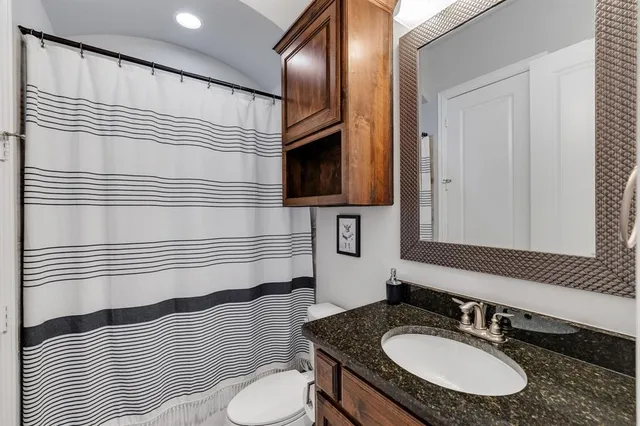 a bedroom with a bed and a large window with the outer view