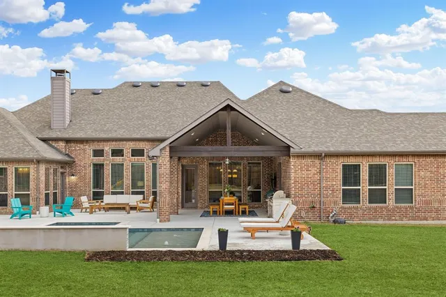 a view of an house with backyard porch and outdoor seating