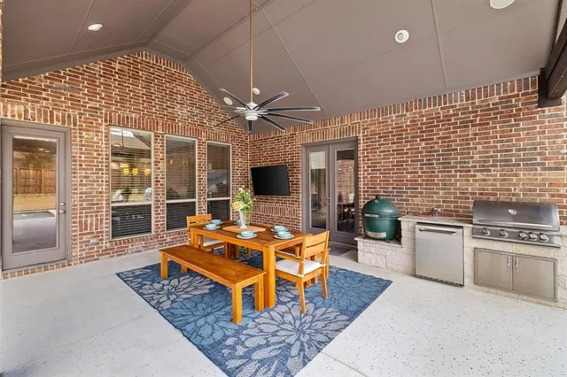 a living room with furniture a fireplace and a open kitchen view