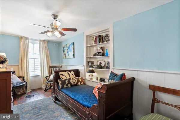 a bedroom with furniture and a flat screen tv