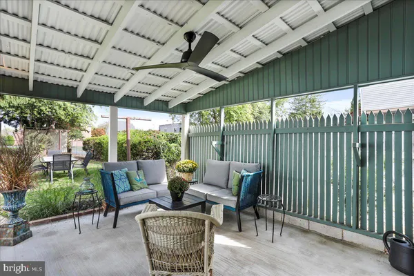 a front view of a house with a tree