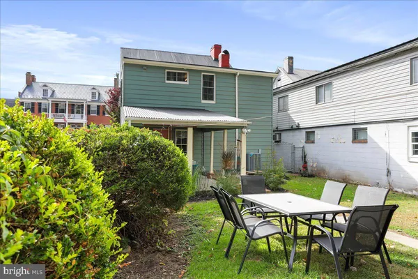 a balcony with furniture and a potted plant