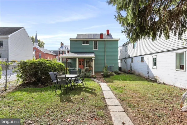 a front view of a house with a yard table and chairs