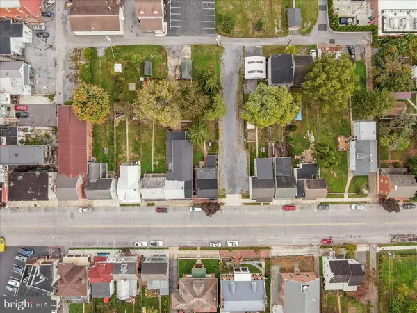 an aerial view of a house with a yard basket ball court and outdoor seating