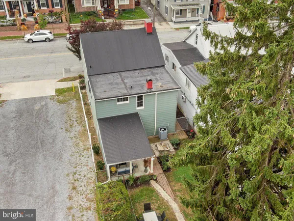 an aerial view of residential building with parking and ocean view