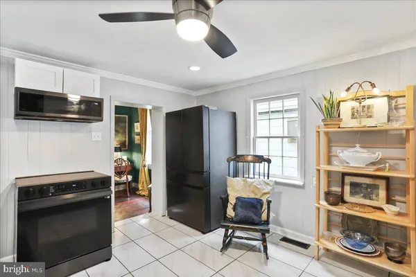 a kitchen with stainless steel appliances kitchen island granite countertop a sink and a stove