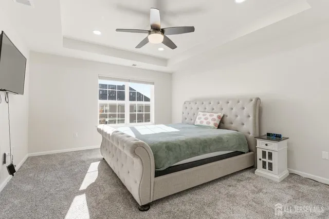 a spacious bedroom with a bed and a chandelier