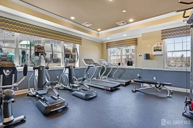 a room with gym equipment and large mirror