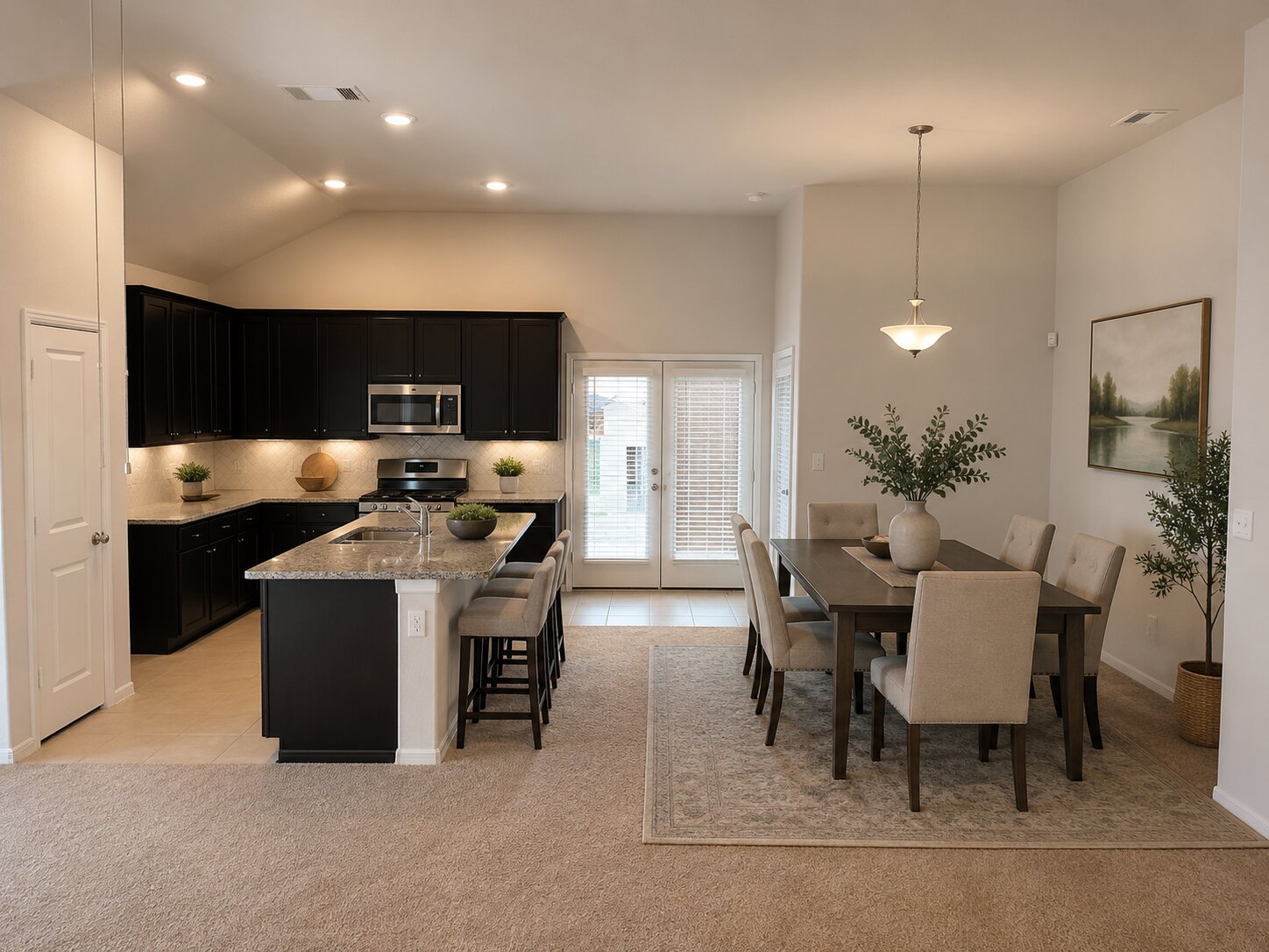 1003 Cherrystone Loop Buda, TX 78610 - Photo 5 of 27 a kitchen with stainless steel appliances kitchen island granite countertop a cabinets and a view of living room