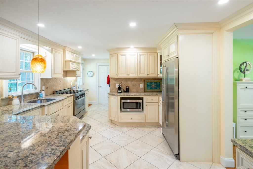96 Conant Road Weston, MA 02493 - Photo 24 of 42 a kitchen with stainless steel appliances granite countertop a stove a sink and a refrigerator