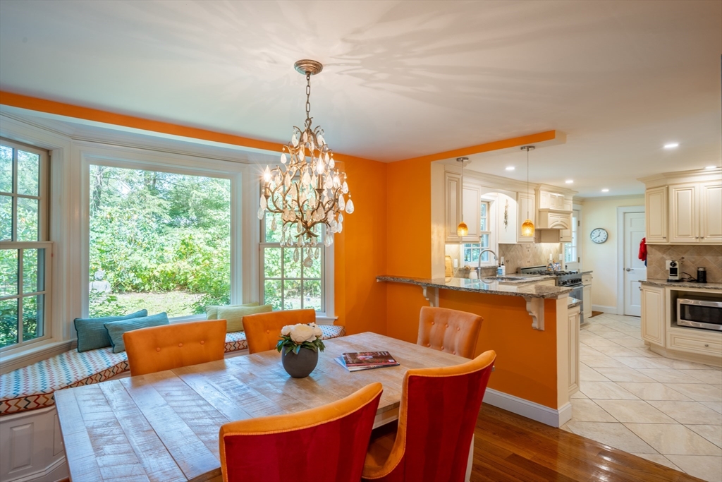 96 Conant Road Weston, MA 02493 - Photo 25 of 42 a view of a dining room and livingroom with furniture wooden floor a chandelier