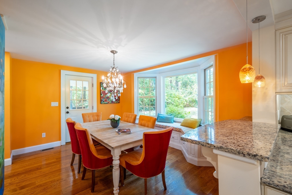 96 Conant Road Weston, MA 02493 - Photo 28 of 42 a view of a dining room with furniture a chandelier and wooden floor