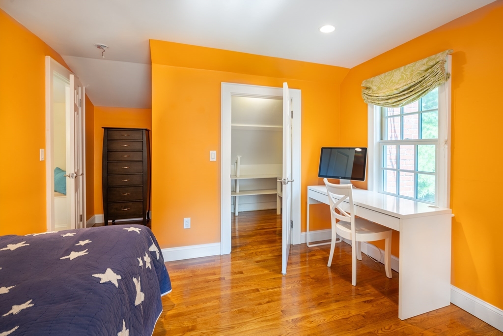 96 Conant Road Weston, MA 02493 - Photo 31 of 42 a bedroom with a bed and a flat screen tv
