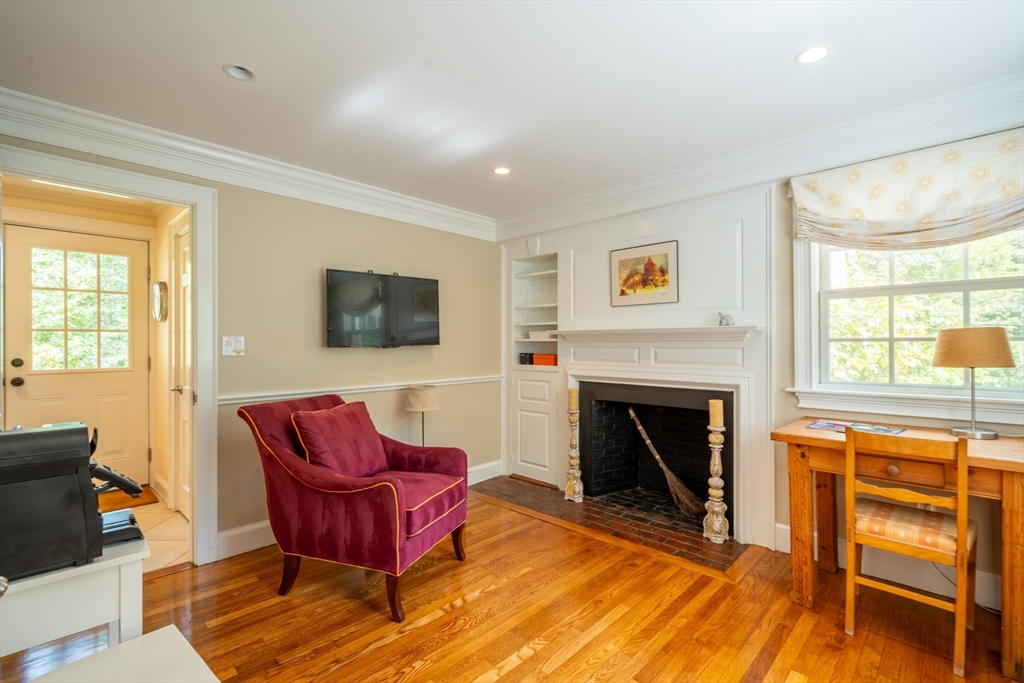 96 Conant Road Weston, MA 02493 - Photo 32 of 42 a living room with furniture a flat screen tv and a fireplace