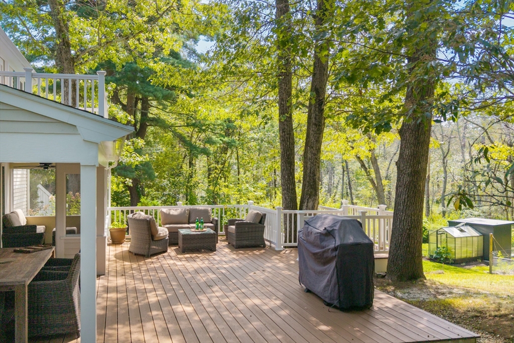 96 Conant Road Weston, MA 02493 - Photo 8 of 42 a view of a patio with couches plants and large trees