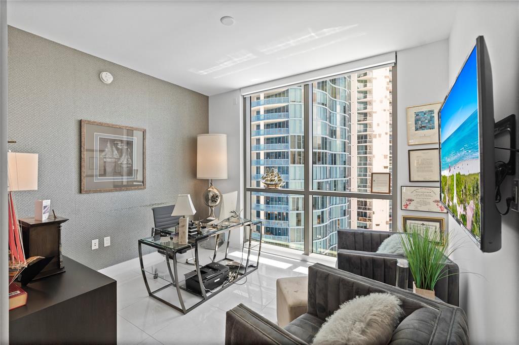 100 East Las Olas Boulevard, Unit 1901 Fort Lauderdale, FL 33301 - Photo 28 of 83 a living room with furniture a flat screen tv and a window