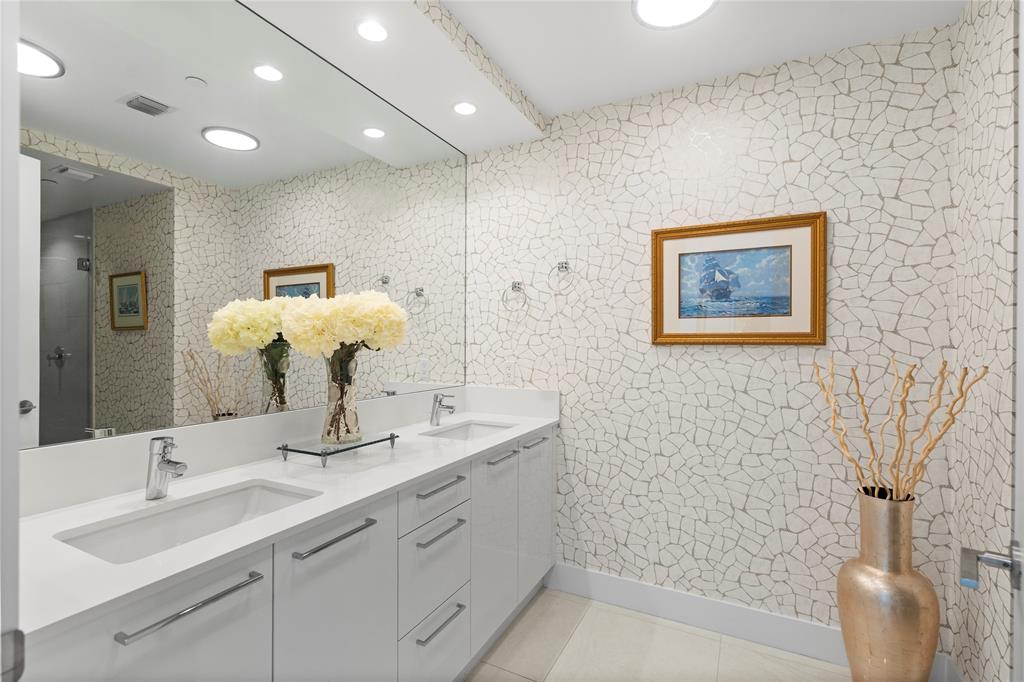 100 East Las Olas Boulevard, Unit 1901 Fort Lauderdale, FL 33301 - Photo 33 of 83 a bathroom with a sink a toilet and mirror