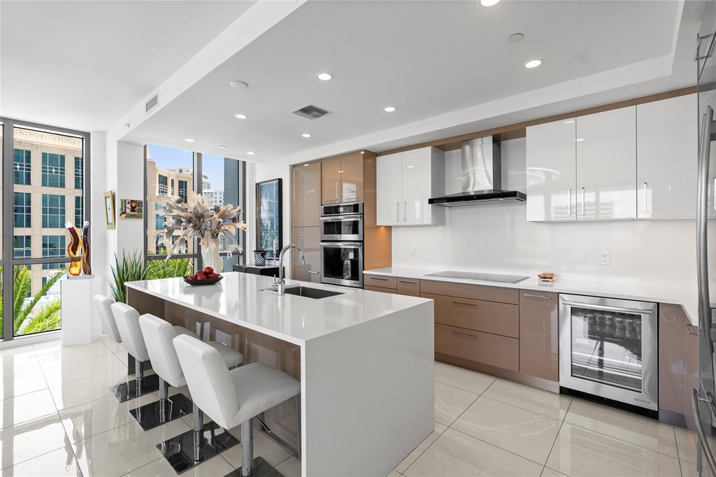 100 East Las Olas Boulevard, Unit 1901 Fort Lauderdale, FL 33301 - Photo 41 of 83 a kitchen with stainless steel appliances kitchen island granite countertop a sink and cabinets