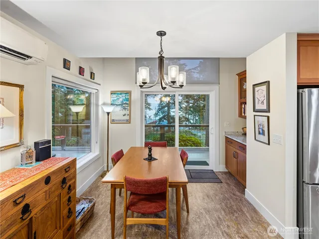 a very nice looking living room with a large window a dining table and chairs
