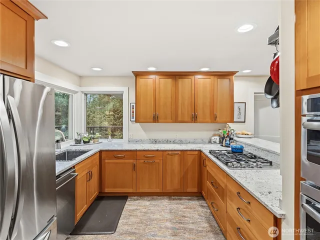 a kitchen with a sink stove and refrigerator