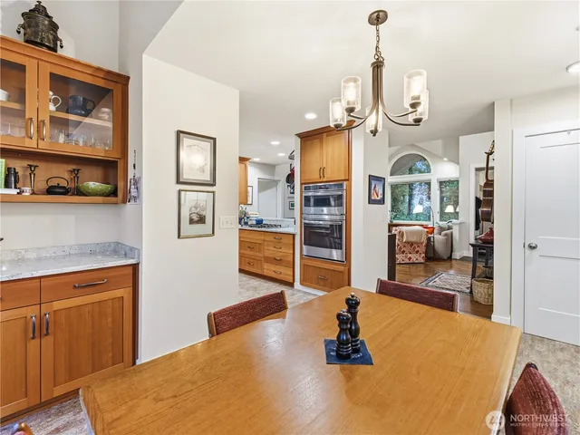 a living room with stainless steel appliances kitchen island granite countertop furniture and a view of kitchen