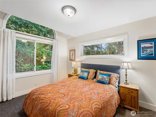 a bedroom with a large bed and a large window