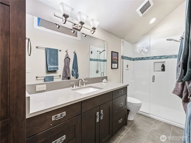 a bathroom with a double vanity sink and a mirror