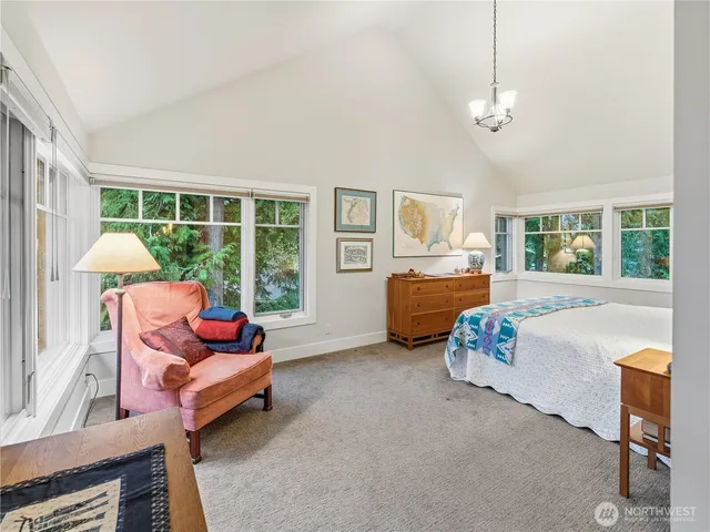 a bedroom with furniture and a large window
