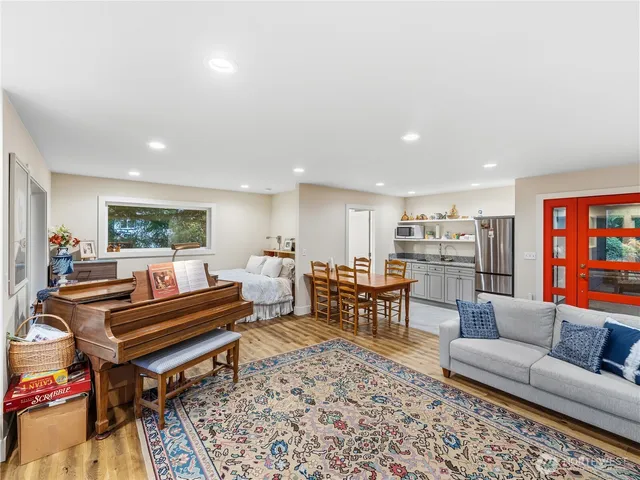 a living room with furniture kitchen view and a table