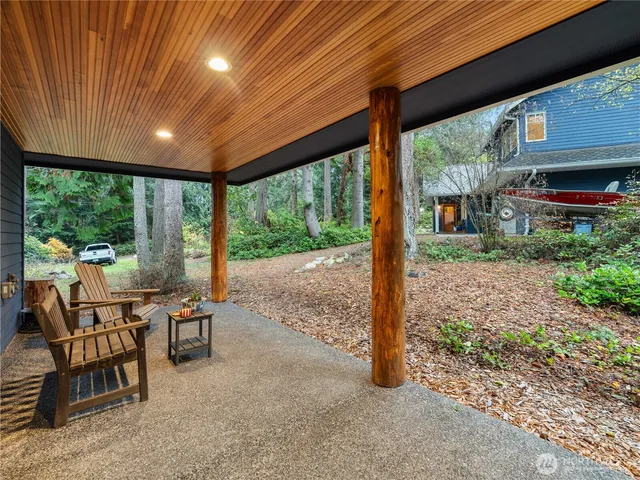 a view of a patio with a table chairs and a backyard
