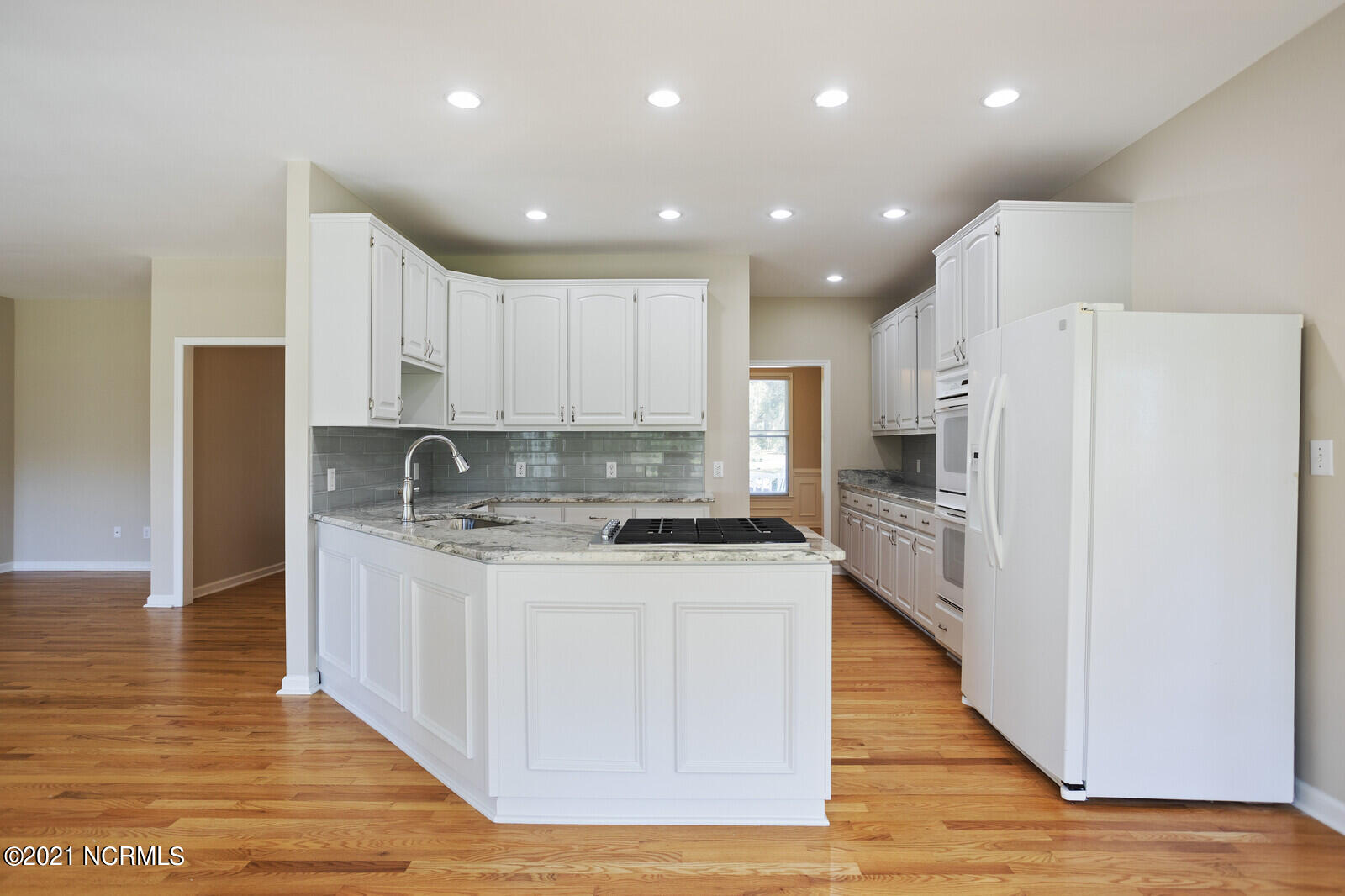 1228 Liberty Landing Road Southeast Winnabow, NC 28479 - Photo 18 of 94 Kitchen has new granite countertops, backsplash and painted cabinets.