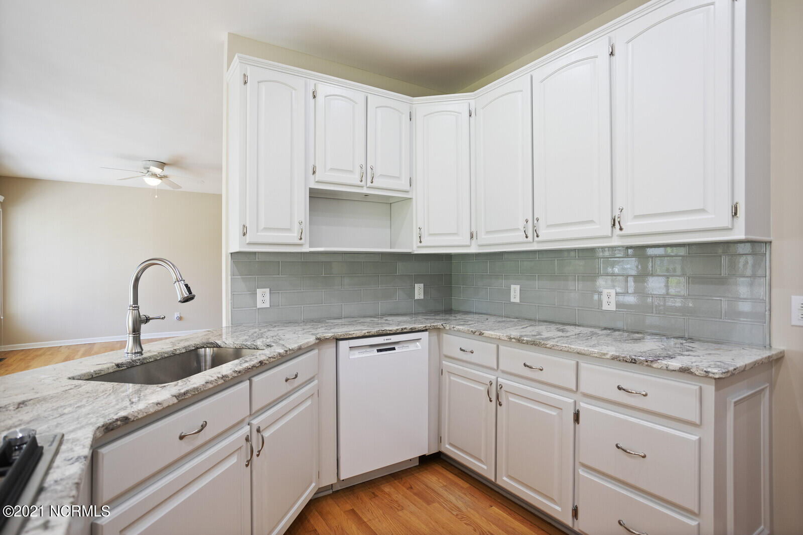 1228 Liberty Landing Road Southeast Winnabow, NC 28479 - Photo 19 of 94 Kitchen has new granite countertops, backsplash and painted cabinets.