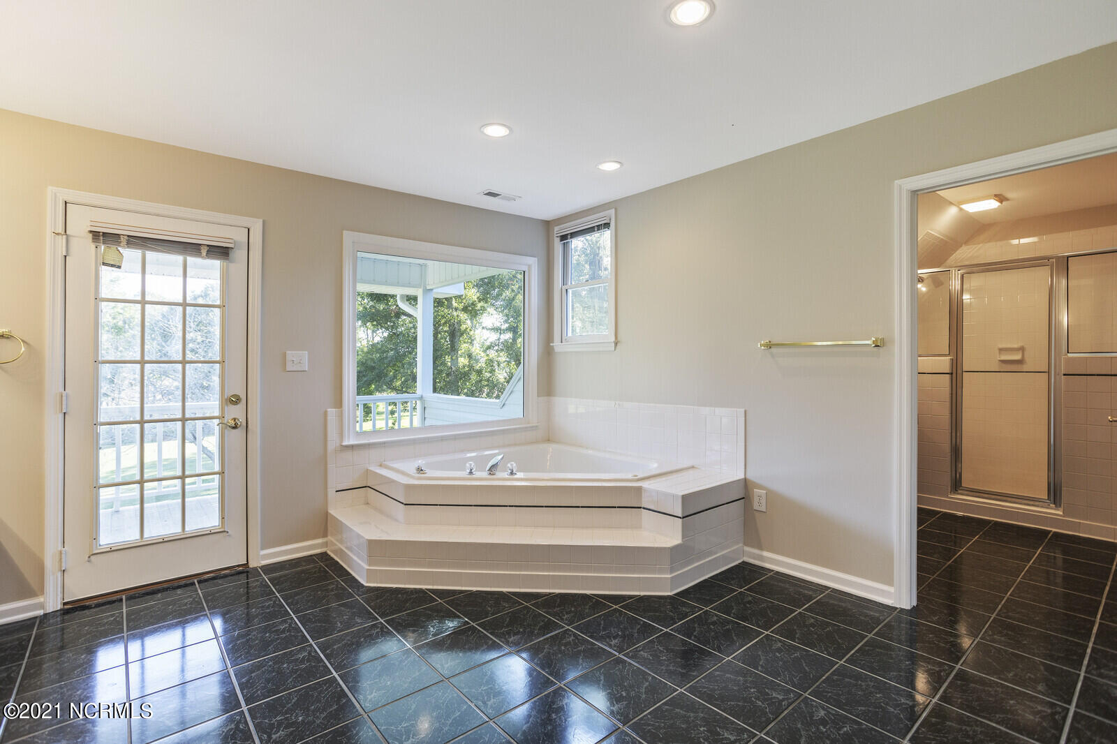 1228 Liberty Landing Road Southeast Winnabow, NC 28479 - Photo 44 of 94 Master bath has a corner tub and French door to the back balcony.