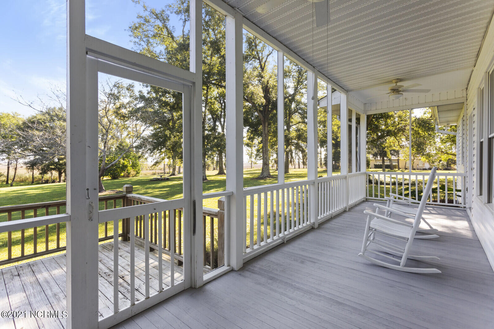 1228 Liberty Landing Road Southeast Winnabow, NC 28479 - Photo 67 of 94 Screened Porch overlooking the back yard with river views in the distance - first floor