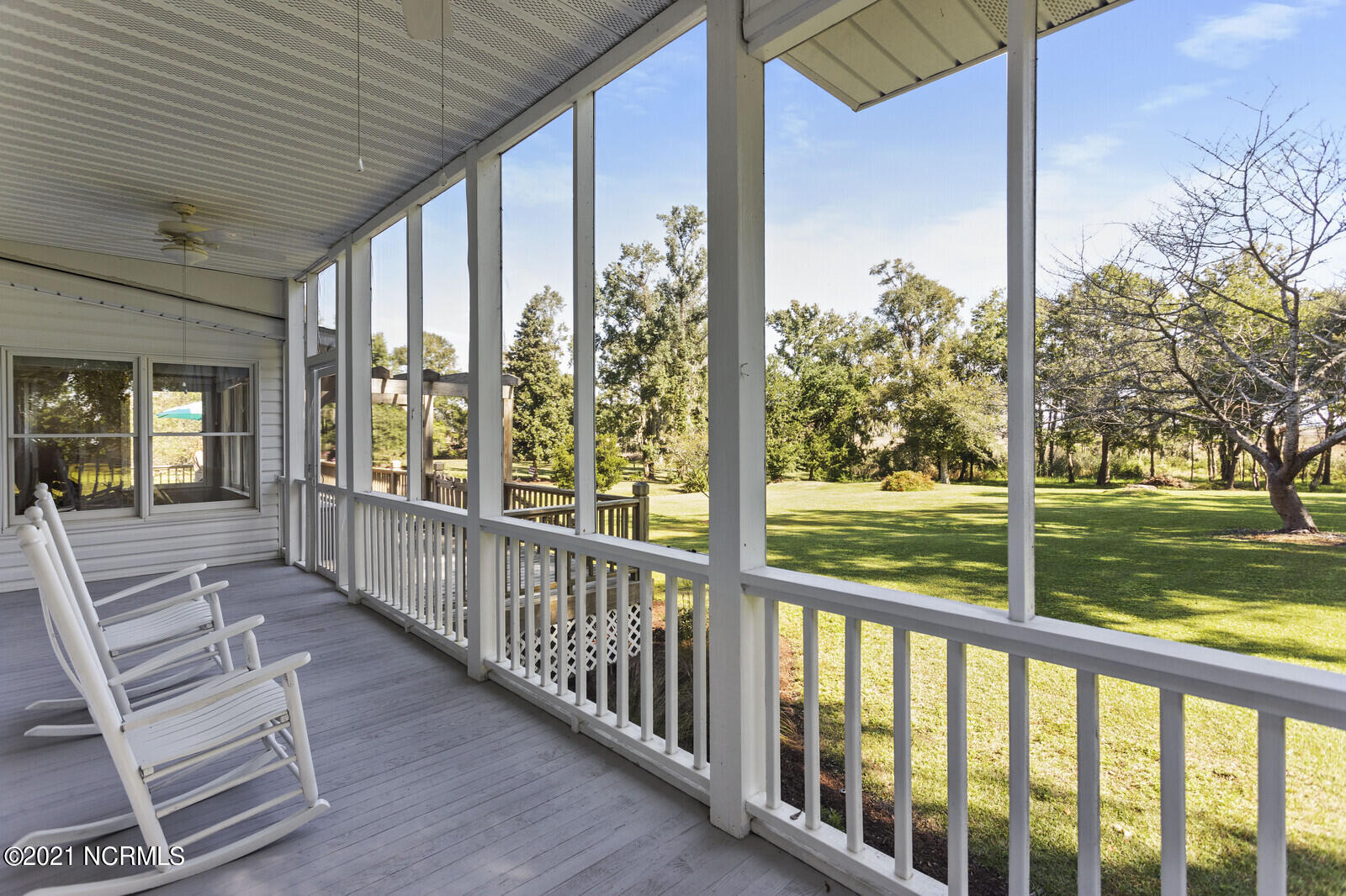 1228 Liberty Landing Road Southeast Winnabow, NC 28479 - Photo 68 of 94 Screened Porch overlooking the back yard with river views in the distance - first floor