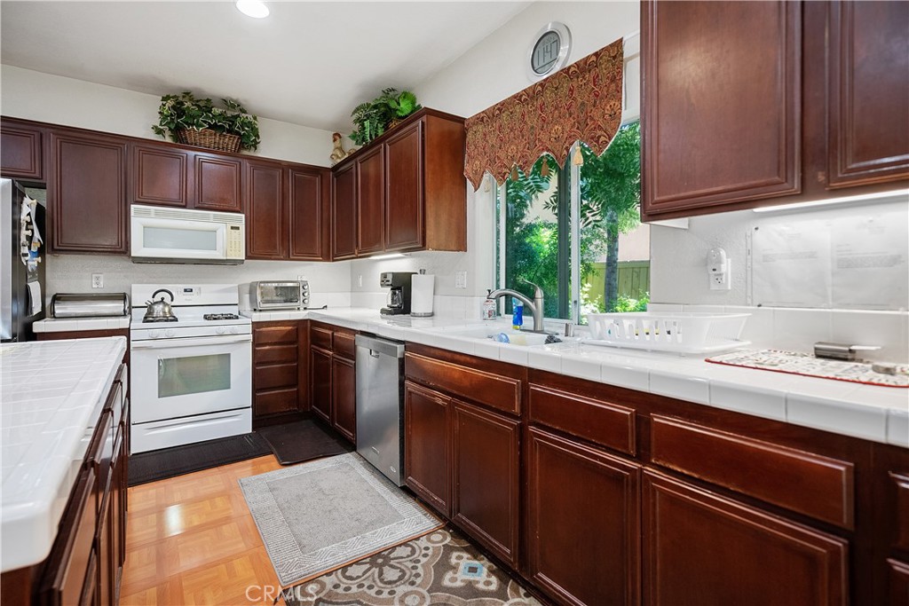 33391 Agate Street Menifee, CA 92584 - Photo 16 of 38 a kitchen with a sink stove and cabinets