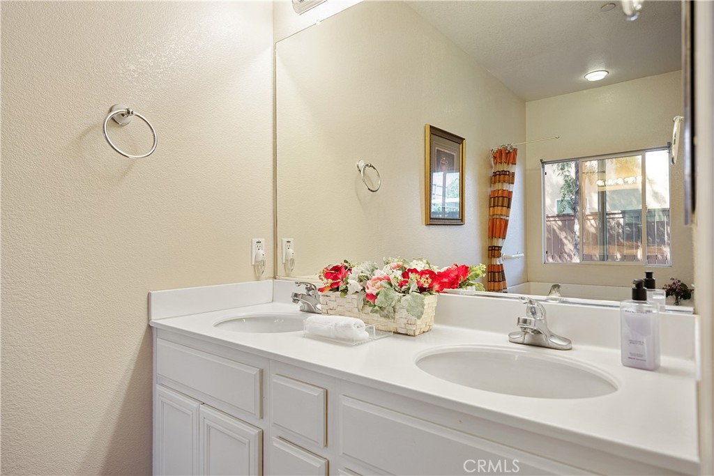 33391 Agate Street Menifee, CA 92584 - Photo 25 of 38 a bathroom with a sink and a mirror
