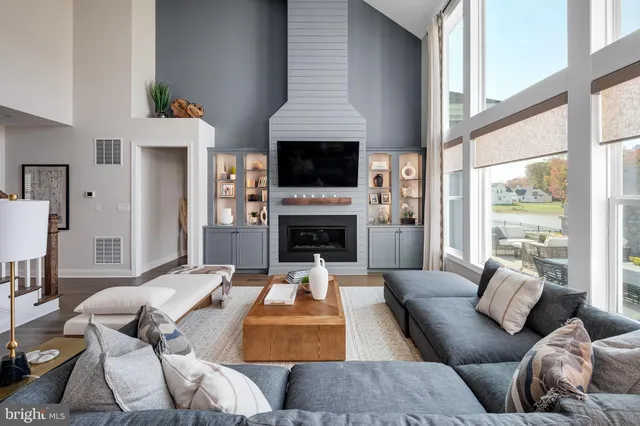 a living room with furniture fireplace and flat screen tv