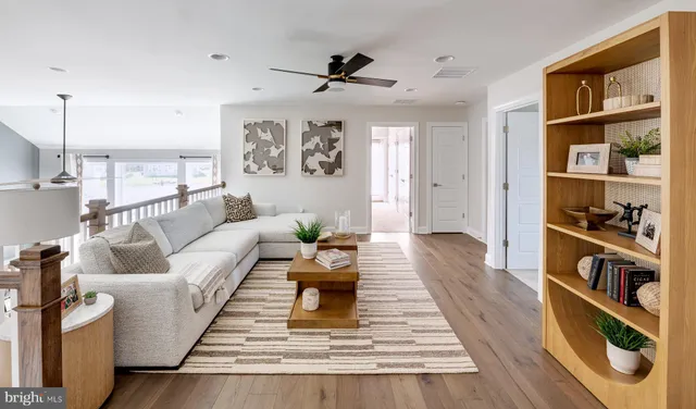 a living room with furniture and a book shelf