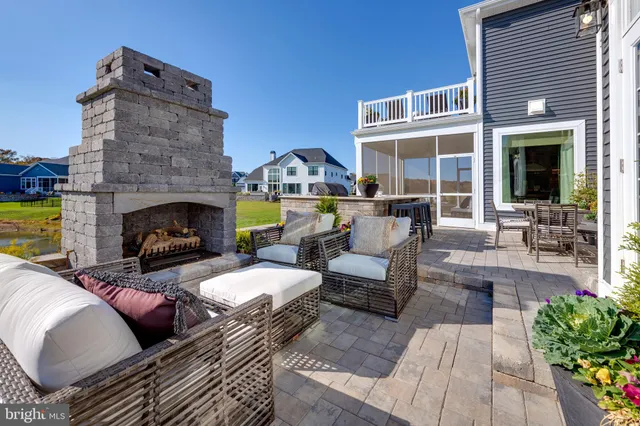 a view of a patio with couches table and chairs with potted plants