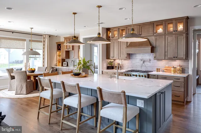a kitchen with a table chairs stove and cabinets