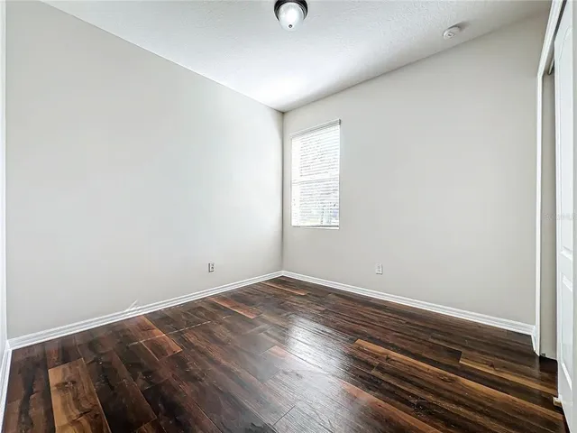 a view of room with window and hardwood floor